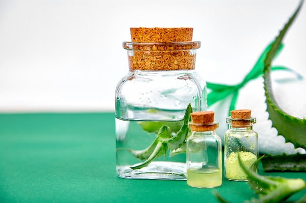 Aloe vera oil in glass bottle and towel for spa