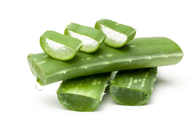 Aloe vera pieces of leaf isolated on white surface. Drop of juice from leaf.