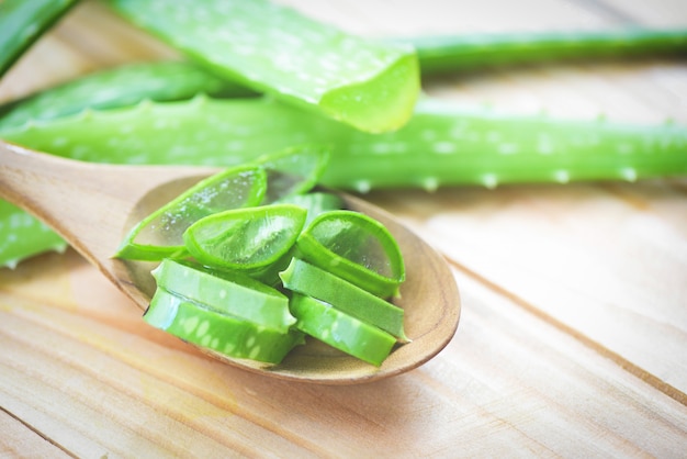 Aloe vera plant slice on wood table close up of fresh aloe vera leaf with gel natural herbs and herbal medicines 