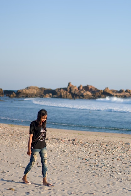 Alone woman walking enjoying beauty beach