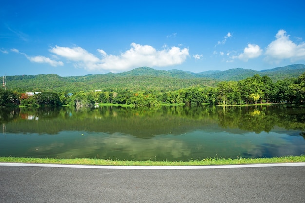 Along road landscape view in  Forested Mountain blue sky background with white clouds