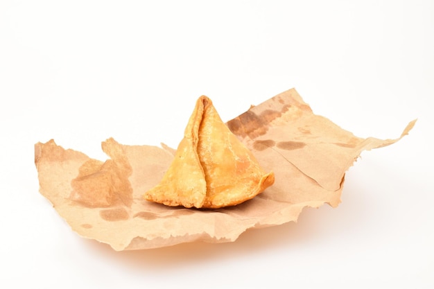 Aloo samosa in wrapper isolated on white background