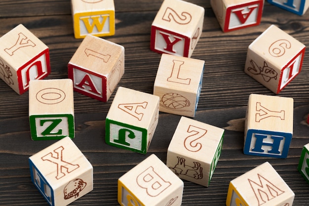 Alphabet blocks ABC on wooden table.