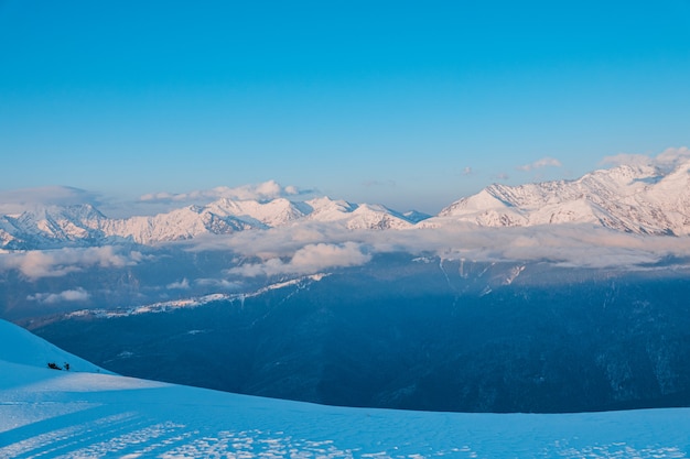 Alpine landscape of snow covered mountains and blue sky