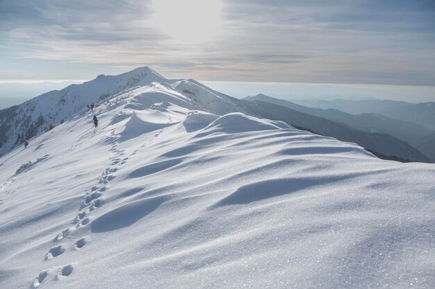 Alpine mountains landscape with white snow and dramatic overcast sky