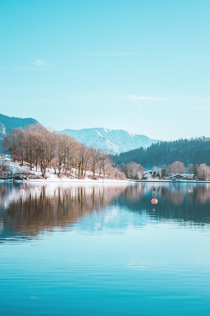 Alpine mountains view and picturesque fishing village on snowy coast of the lake Tegernsee, Bavaria