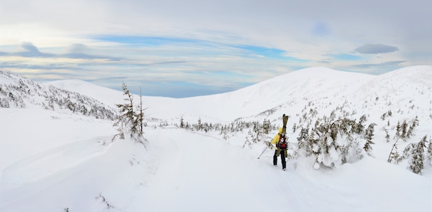 Alpine touring skier hiking in winter mountains. Carpathians, Ukraine.