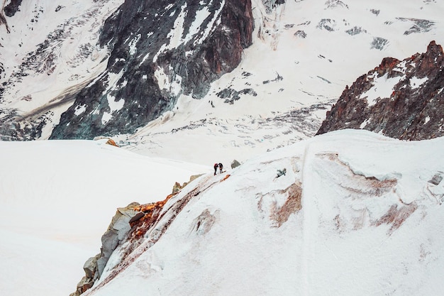 Alpinism in Mont Blanc mountains snowy pass in french Alps peak Aiguille du Midi France