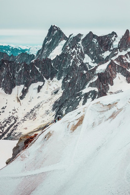 Alpinism in Mont Blanc mountains snowy pass in french Alps peak Aiguille du Midi France