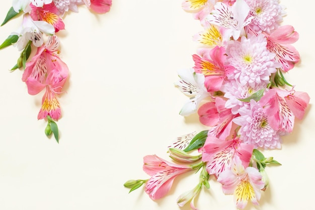 Alstroemeria and chrysanthemums flowers on yellow background