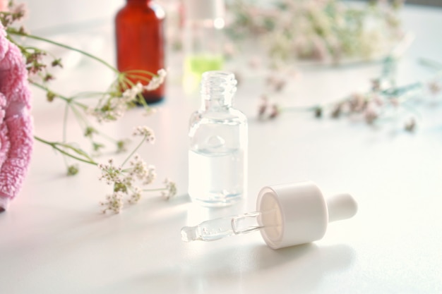 Alternative medicine. Leaves of medicinal herbs, a bottle on a white background.