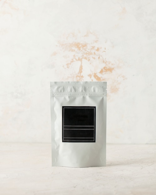 Aluminum bag for tea coffee spices and bulk substances with a black label for signature on a light b...