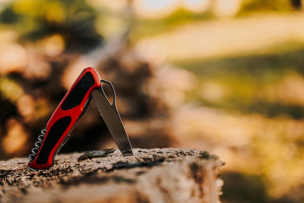 Aluminum knife handle on the wood in nature multipurpose pocket knife on wood