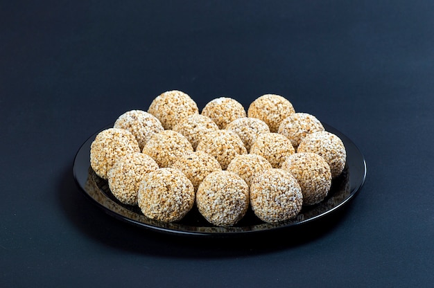 Amaranth ladoo or Rajgira laddu or Cholai ke laddo in black plate on black background.