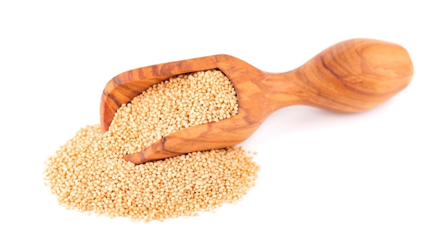 Amaranth seeds in wooden scoop, isolated on white. Organic dry raw amaranth beans.