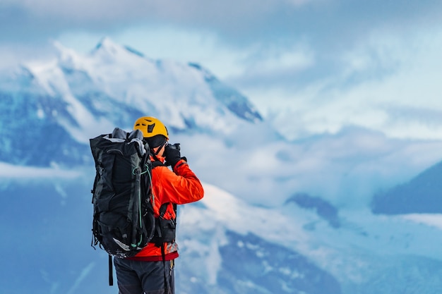 An amateur mountaineer photographer with a large backpack