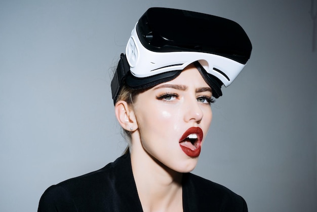 Amazed attractive girl with vr device woman in vr headset virtual reality goggles connection future