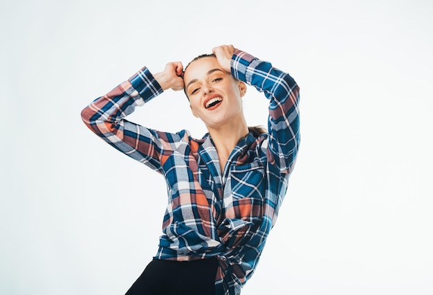 Amazed cheerful pretty lady dressed checkered shirt Happy attractive model showing expression