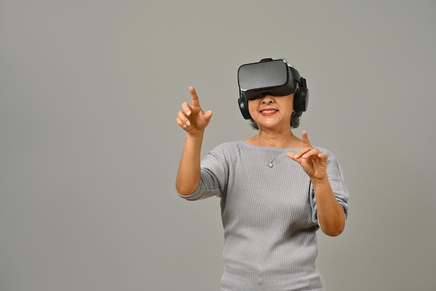 Amazed senior woman VR headset enjoying virtual reality experience Modern technologies innovations and gadgets