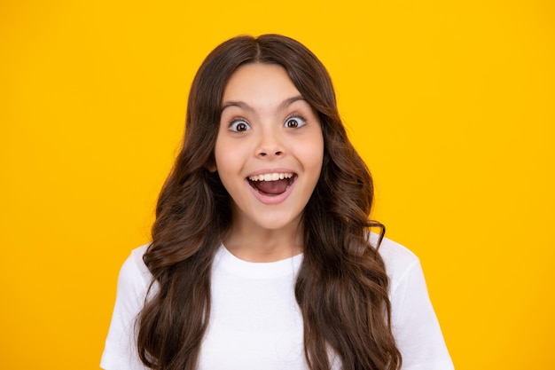 Amazed teen girl Excited expression cheerful and glad Portrait of emotional positive teenage child girl shouting in amazement or astonishment face astonished with surprise