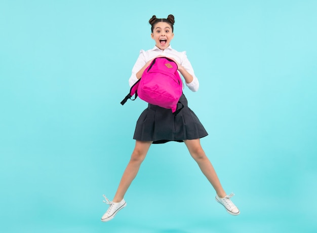 Amazed teenager Back to school Teenager schoolgirl school uniform with backpack Jump and run School