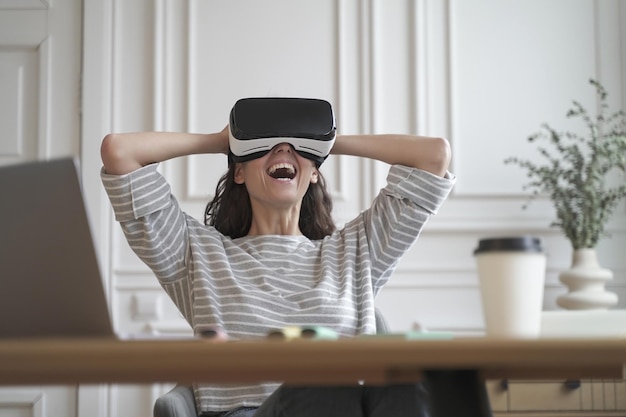 Amazed woman office employee in VR glasses laughing and leaning back in chair with hands behind head