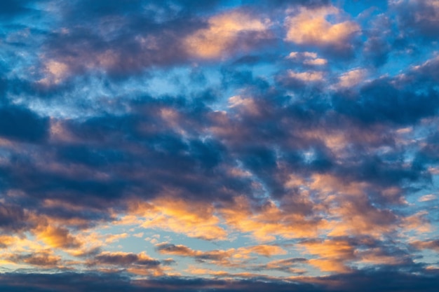 Amazing clouds in blue sky illuminated by rays of sun at sunset to change weather Colorful abstract meteorology background