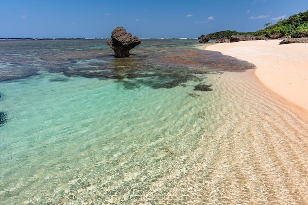 Amazing crystal clear sea waters with glistening surface wavy sands at a paradise beach Okinawa