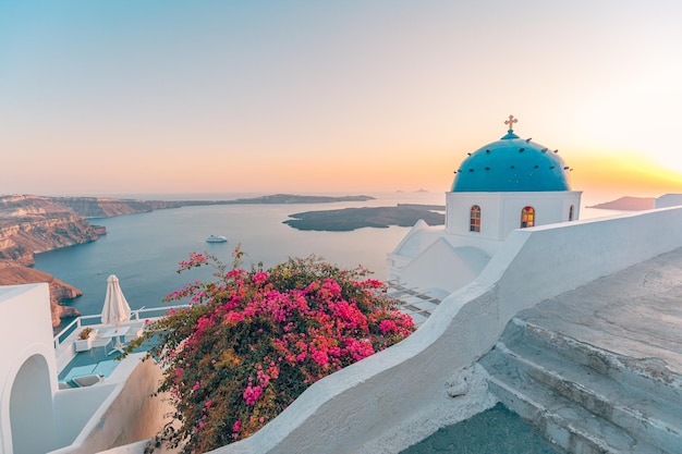 Amazing evening view of Fira, caldera flowers, volcano of Santorini, Greece at sunset