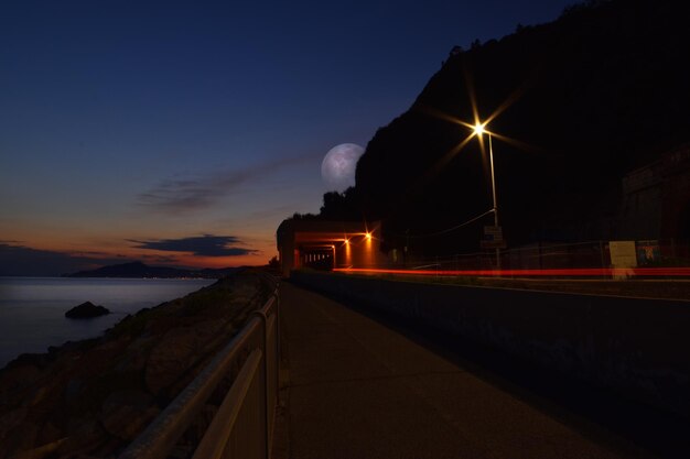 Amazing giant moon reflected on the sea on the Ligurian coast