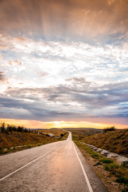 Amazing highway landscape at dawn with dramatic sky