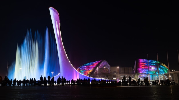 Amazing illuminated musical fountain and Olympic Stadium "Fisht" at night in Sochi, Russia.