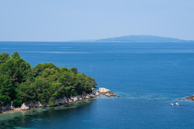 Amazing landscape overlooking a beautiful lagoon pine forest and wild beach Wonderful turquoise water of the Adriatic Sea Mountains are visible on the background