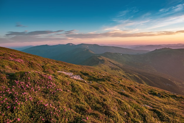 Amazing mountain landscape with colorful vivid sunrise on the blue sky, natural outdoor travel background. Beauty world. Panoramic view.