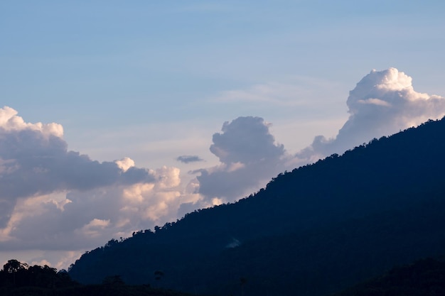 Amazing nature clouds over mountains sunset or sunrise sky background