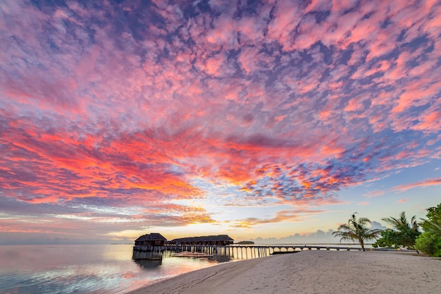 Amazing panoramic sunset Maldives. Luxury resort villas seascape, sea horizon water reflection