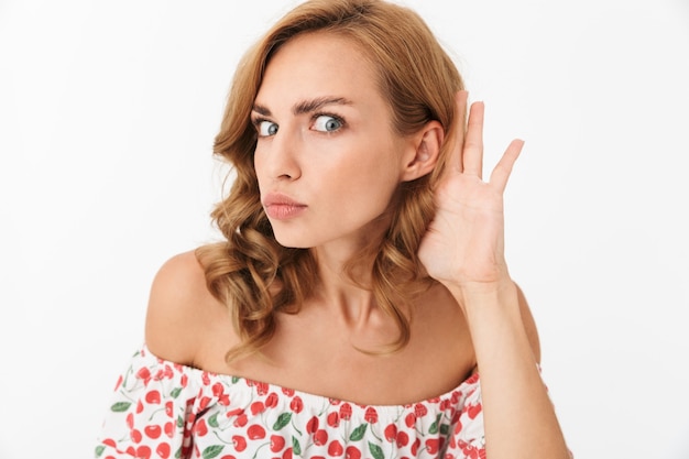 Amazing pretty serious concentrated young woman posing isolated over white wall try to hear you.