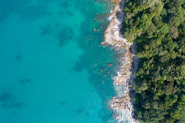 Amazing Sea aerial view Top down seashore nature background Beautiful Tropical beach with rocky mountains and turquoise clear water of Phuket Thailand ocean at sunny summer day Landscape background.