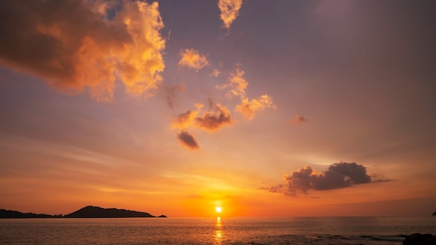 Amazing seascape with sunset clouds over the sea with dramatic sky sunset or sunrise Beautiful nature minimalist background and texture Panoramic nature view landscape Dramatic light sky and clouds.