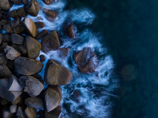 Amazing top view beautiful seashore Aerial view crashing waves on rocks Beautiful sea in Phuket island Thailand