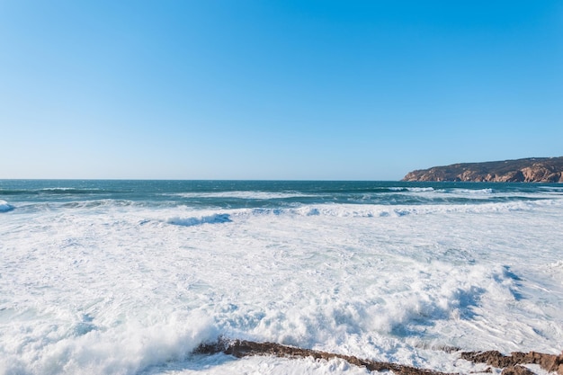 Amazing view of the Atlantic Ocean with waves mountain and clear blue sky Traveling in Portugal