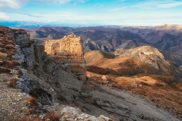 Amazing view of Bermamyt plateau rocks on sunny day Caucasus Mountains on the edge of a cliff in the distance Atmospheric landscape with silhouettes of mountains KarachayCherkessia Russia