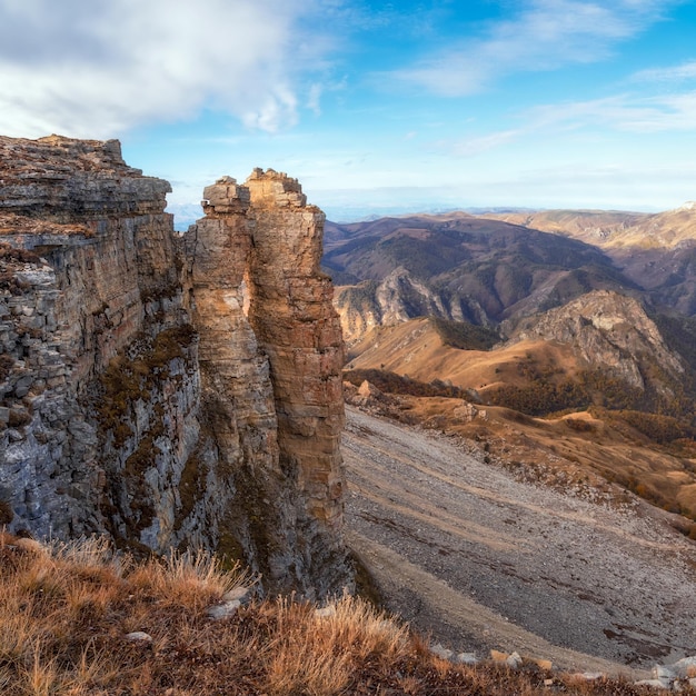 Amazing view of Bermamyt plateau rocks on sunny day Caucasus Mountains on the edge of a cliff in the distance Atmospheric landscape with silhouettes of mountains KarachayCherkessia Russia