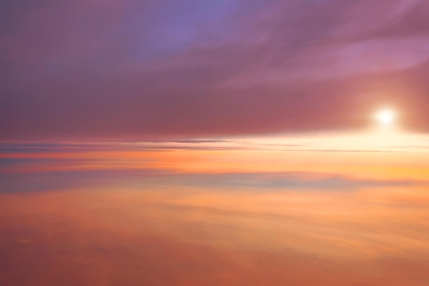 Amazing view from plane between different layers of clouds on the sky sunrise sun