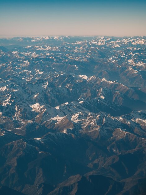 Amazingly beautiful panoramic aerial view of snowcapped mountain ranges of alps flight over alpine