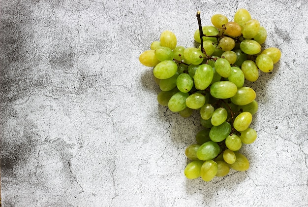 Amber bunch of grapes on a gray concrete