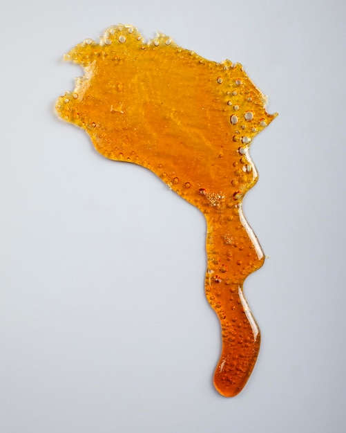 Amber cannabis resin on gray background thc wax rosin