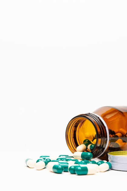 Amber Drug Bottle and Drug Capsule on White Background