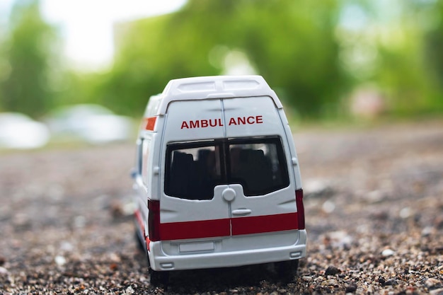 Ambulance car on the asphalt among the trees