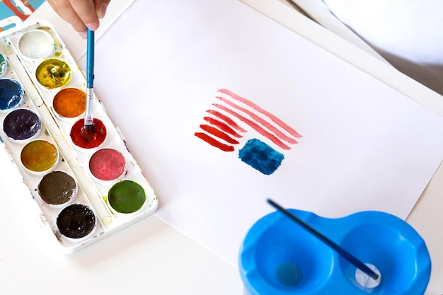 Photo the american 4th of july flag is painted with watercolors by a childs hand patriotism independence day flag day concept day of remembrance